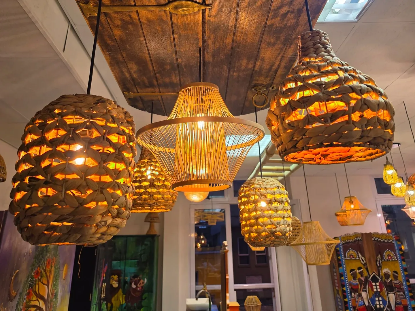 Rattan and water-hyacinth pendants glowing in a cluster